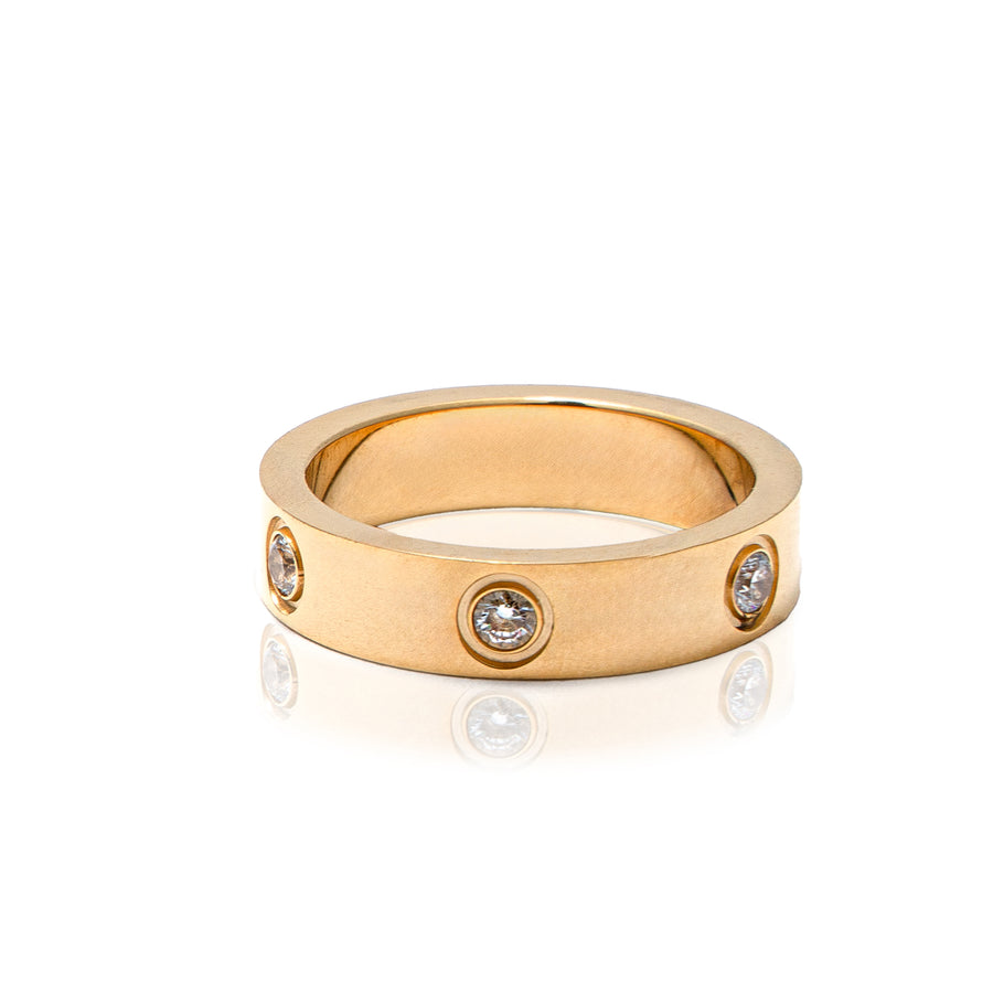 A gold metal ring studded with cubic zirconia gems.