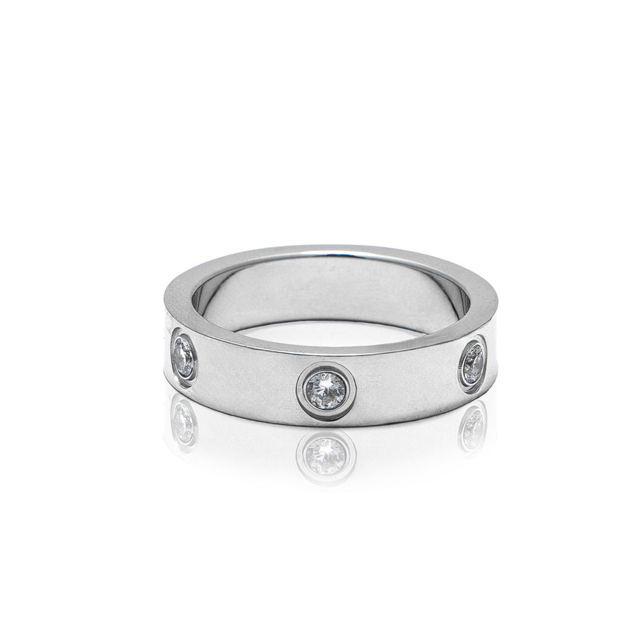 A silver metal ring studded with cubic zirconia gems.