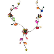A silver princess necklace with assorted jewel tone leaves and flowers. The strands meets at a large center flower with a drop.