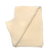 A cream knit scarf with knit border.