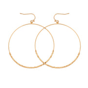 Gold drop earrings. The drops are hoops with seed beads on the lower half.