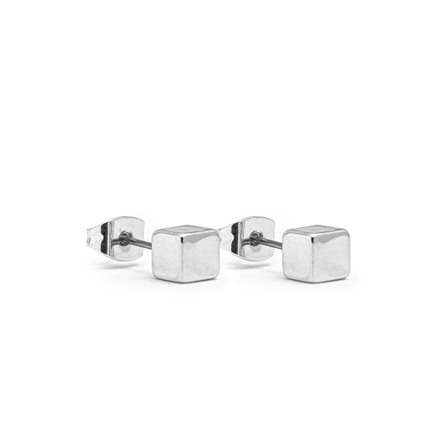 A pair of silver stud earring. The studs are cubes.