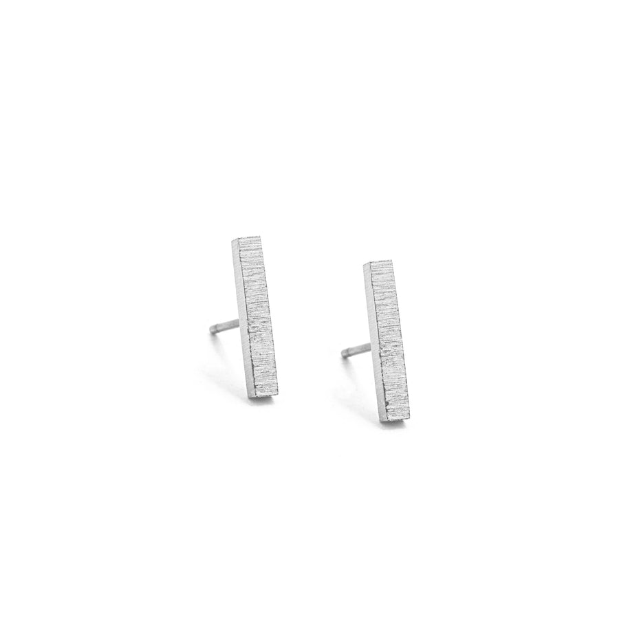 Brushed silver bar stud earrings.
