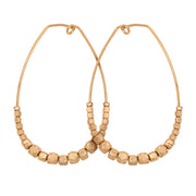 Matte gold oval shaped Teardrop Nugget Earrings with tapered asymmetrical gold nuggets lining lower portion of the earring on white background