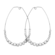 Matte silver oval shaped Teardrop Nugget Earrings with tapered asymmetrical silver nuggets lining lower portion of the earring on white background