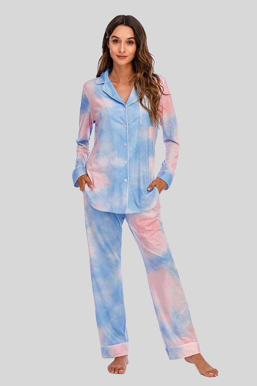 Pastel pink and blue cloud pattern pajama pants and button down top. Features white piping and breast pocket.