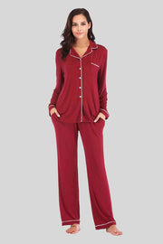 Red pajama pants and button down top. Features white piping and breast pocket.