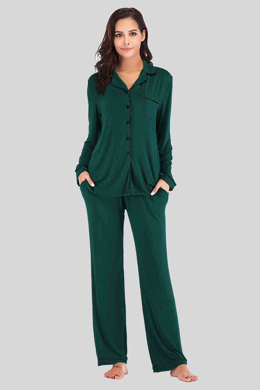 Evergreen pajama pants and button down top. Features black piping and breast pocket.