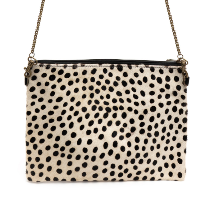 A flat, square, cheetah print bag with a brass chain-link shoulder strap.