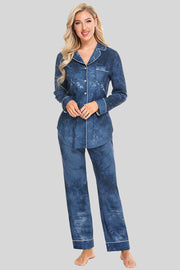 Blue washed pajama pants and button down top. Features white piping and breast pocket.
