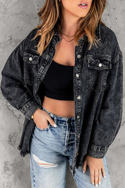 A black, distressed denim shirt jacket with a raw hem.