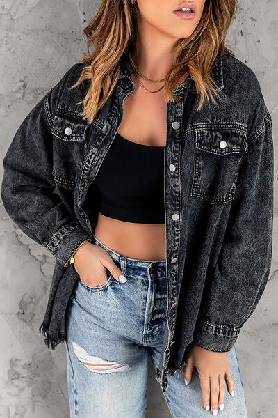 A black, distressed denim shirt jacket with a raw hem.
