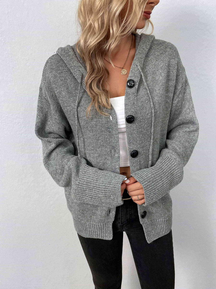 A marled grey, knit sweater with a drawstring hood and large black buttons.