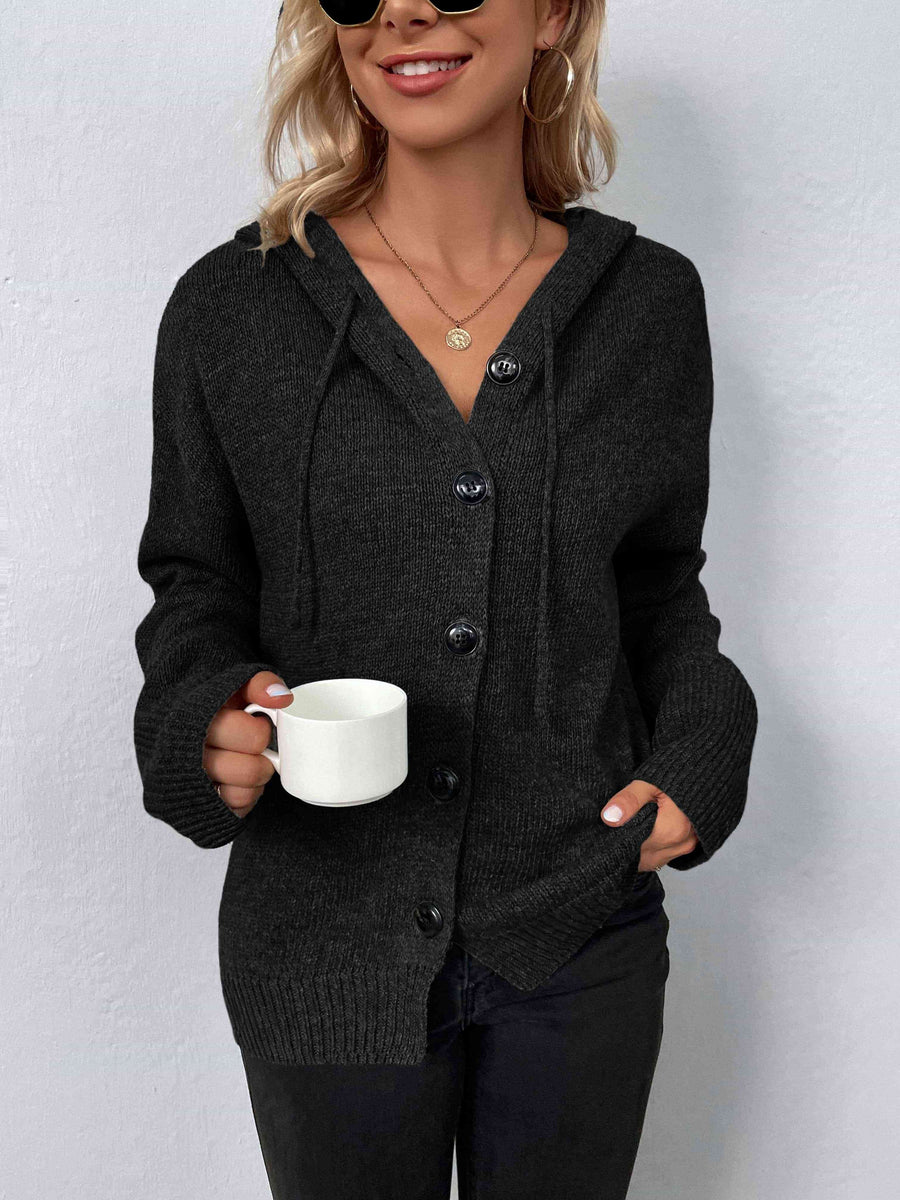 A marled black, knit sweater with a drawstring hood and large black buttons.