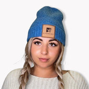 A model wearing the cobalt cashmere beanie.