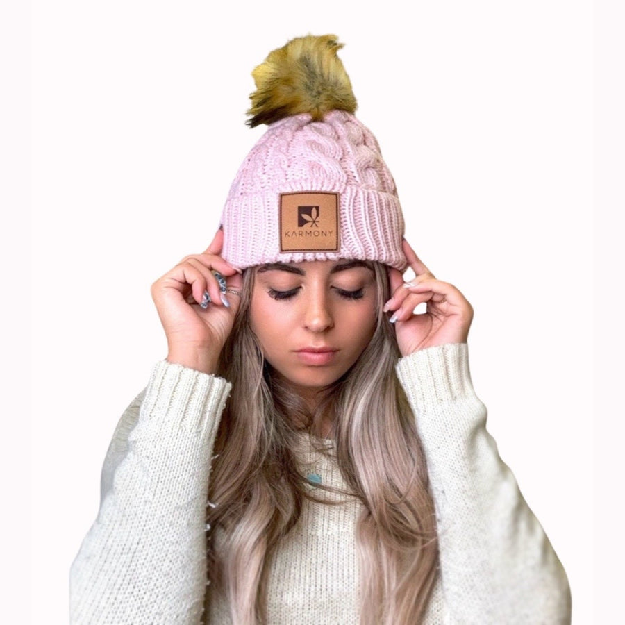 Model wearing the pink cable knit beanie.