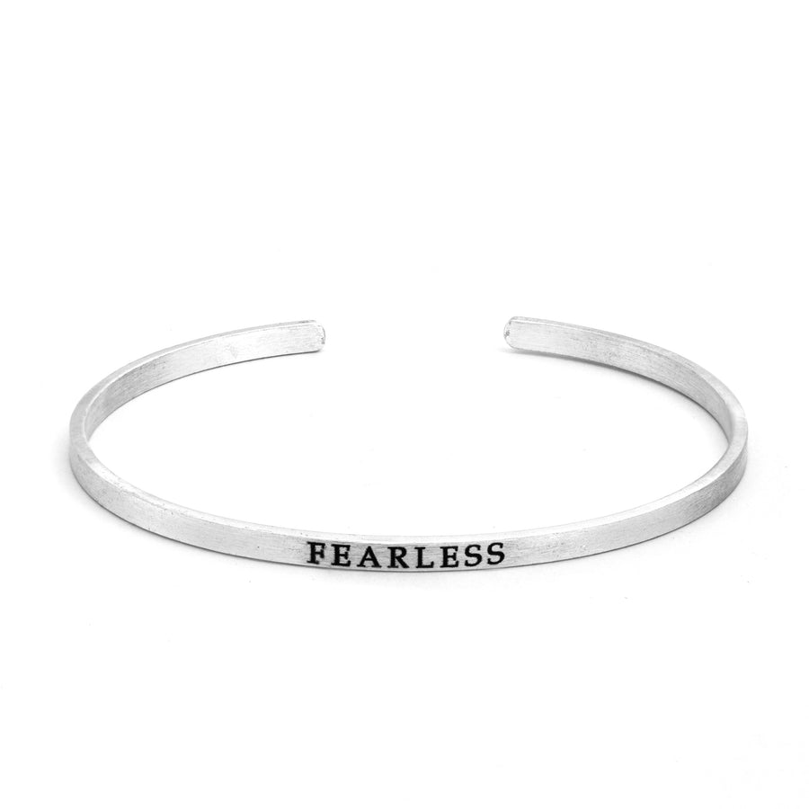 Silver Fearless Slim Cuff Bracelet in matte silver with "fearless" text inscribed in black lettering on white background
