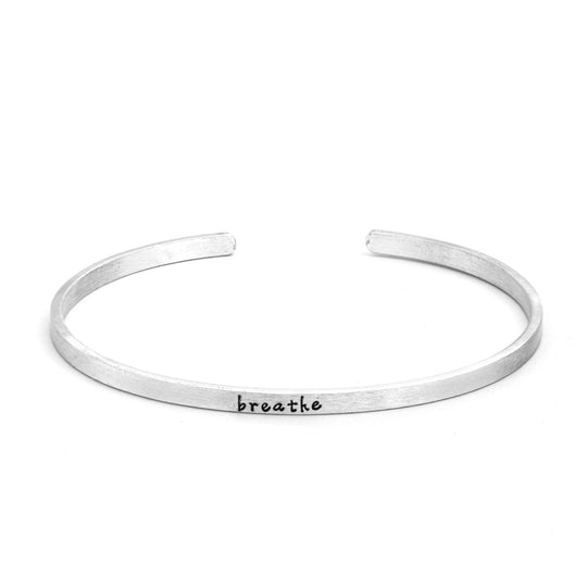 Mindfulness Silver Fearless Slim Cuff Bracelet in matte silver with "breathe" text inscribed in black lettering on white background