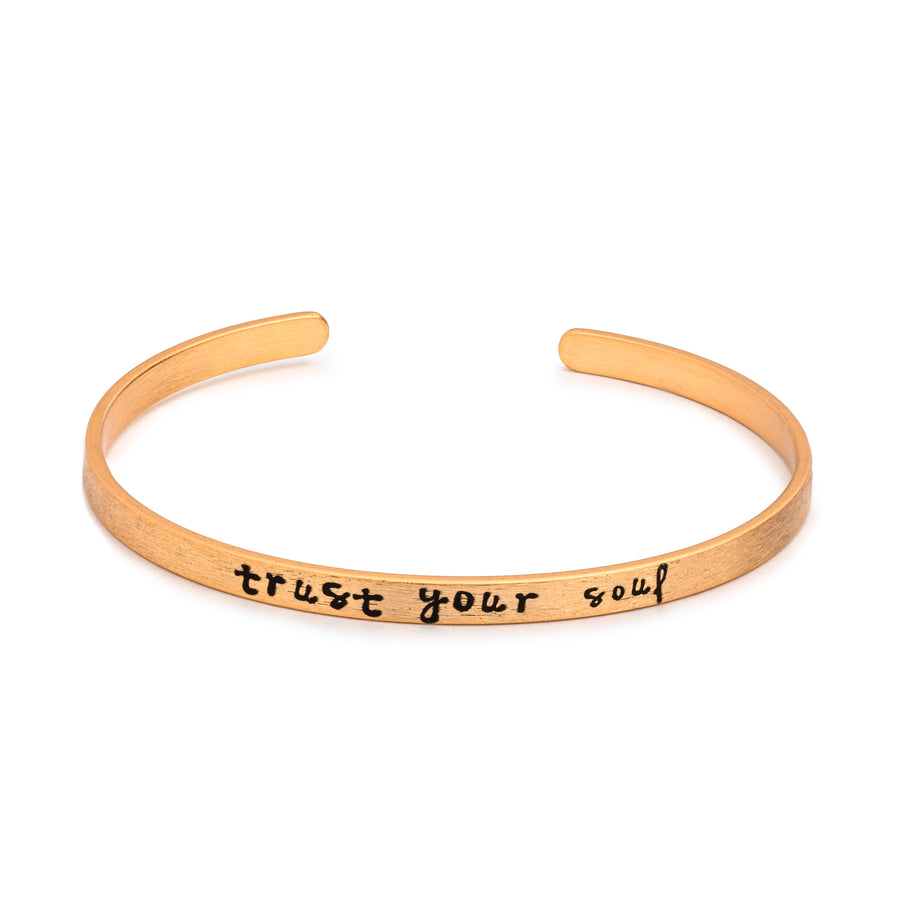 Spiritual Silver Fearless Slim Cuff Bracelet in matte gold with "trust your soul" text inscribed in black lettering on white background