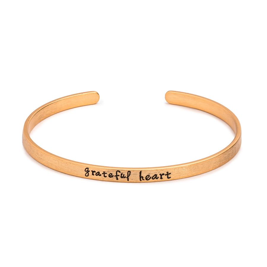 Sentimental Silver Fearless Slim Cuff Bracelet in matte gold with "grateful heart" text inscribed in black lettering on white background