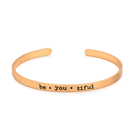Sentimental Silver Fearless Slim Cuff Bracelet in matte gold with "be•you•tiful" text inscribed in black lettering on white background
