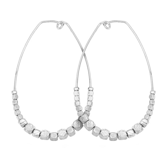Matte silver oval shaped Teardrop Nugget Earrings with tapered asymmetrical silver nuggets lining lower portion of the earring on white background