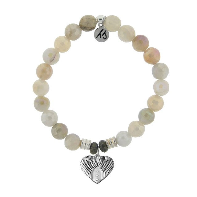 A T. Jazelle bracelet with a silver heart-shaped angel wings charm and shimmering, faceted off-white beads.