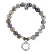 A T. Jazelle bracelet with a round, cut out clock with roman numerals charm and shimmering, faceted grey beads.