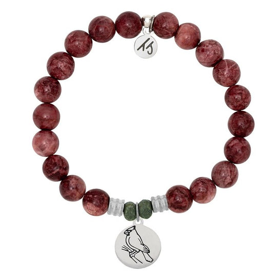 A T. Jazelle bracelet with a round, silver cardinal charm and polished, purplish-red stone beads.