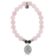 A T. Jazelle bracelet with an oval, silver charm with two stars and polished, light pink beads.