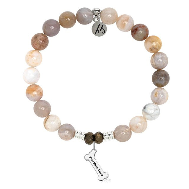 A T. Jazelle bracelet with a silver dog bone charm that reads fur ever love, and polished cream stone beads.