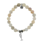A T. Jazelle bracelet with a silver champagne flute charm and polished, faceted off-white beads.