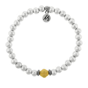 A T. Jazelle Cape Bracelet with silver stainless steel beads and a knotted gold center bead.