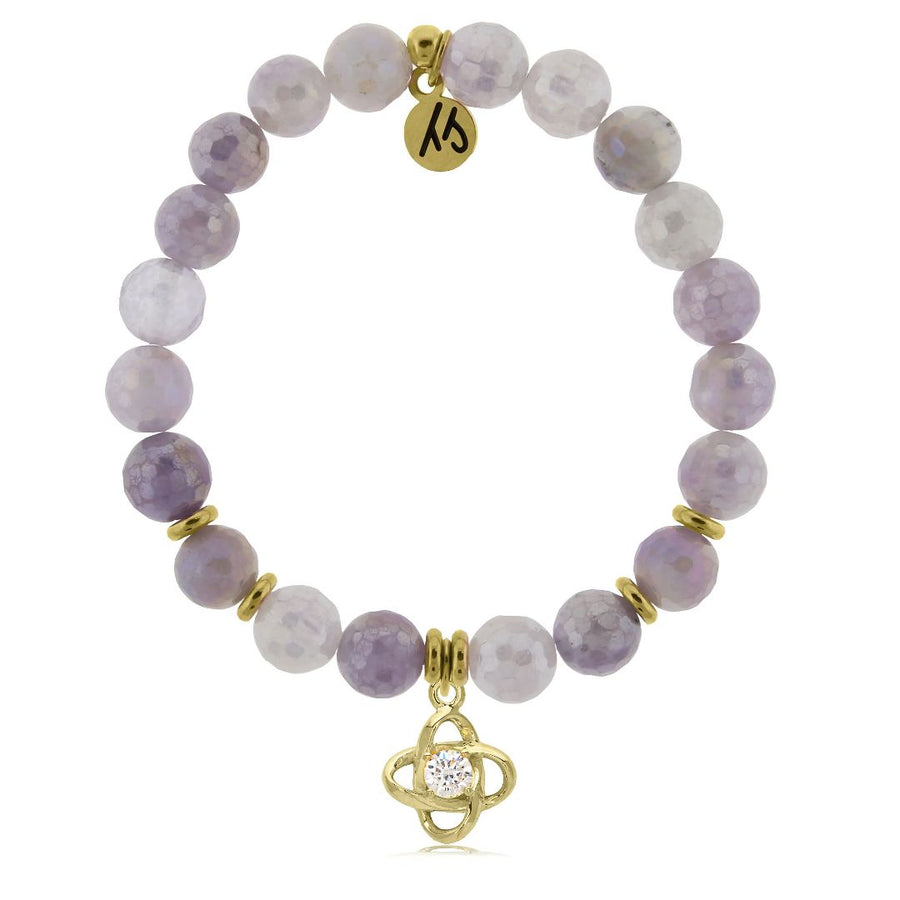 A T. Jazelle bracelet with a round, silver protection symbol charm and iridescent white and lavender purple beads.