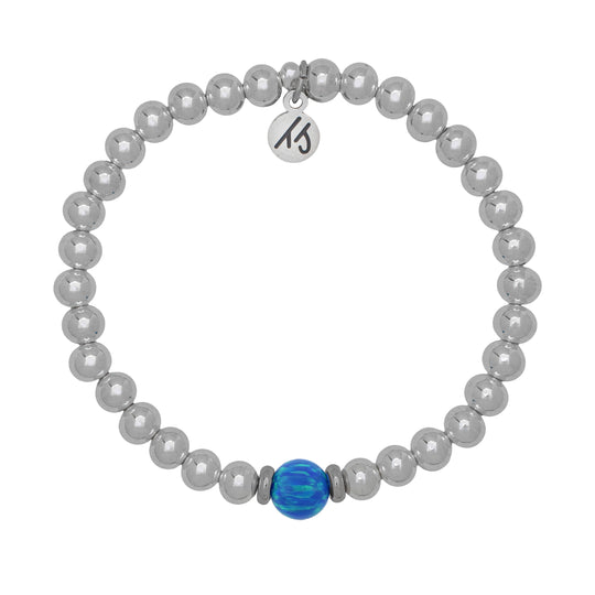 A T. Jazelle Cape Bracelet with silver stainless steel beads. The center bead is a deep, opalescent blue.