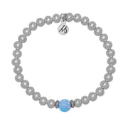 A T. Jazelle Cape Bracelet with silver stainless steel beads and a light blue opalescent center bead.